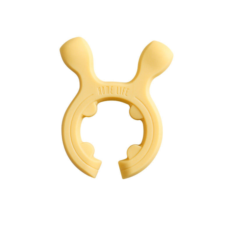 Multifunksjonelt silikonstativ for grytehåndtak og stekespade