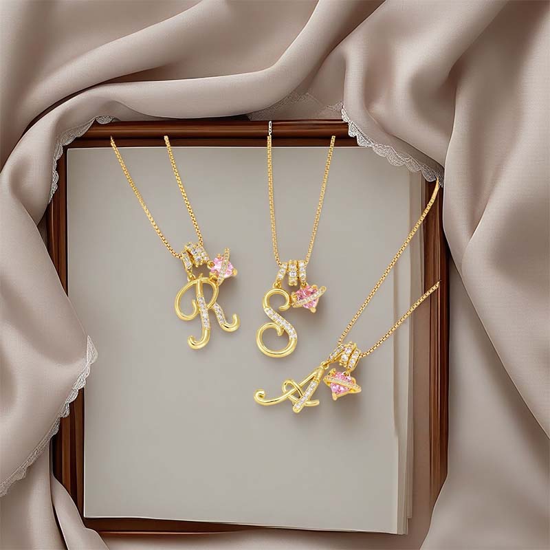 Halskjede med rosa hjerte- og initialanheng