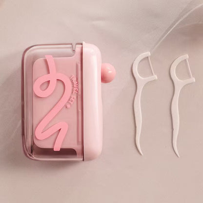 Automatisk popup-dispenser for tanntråd
