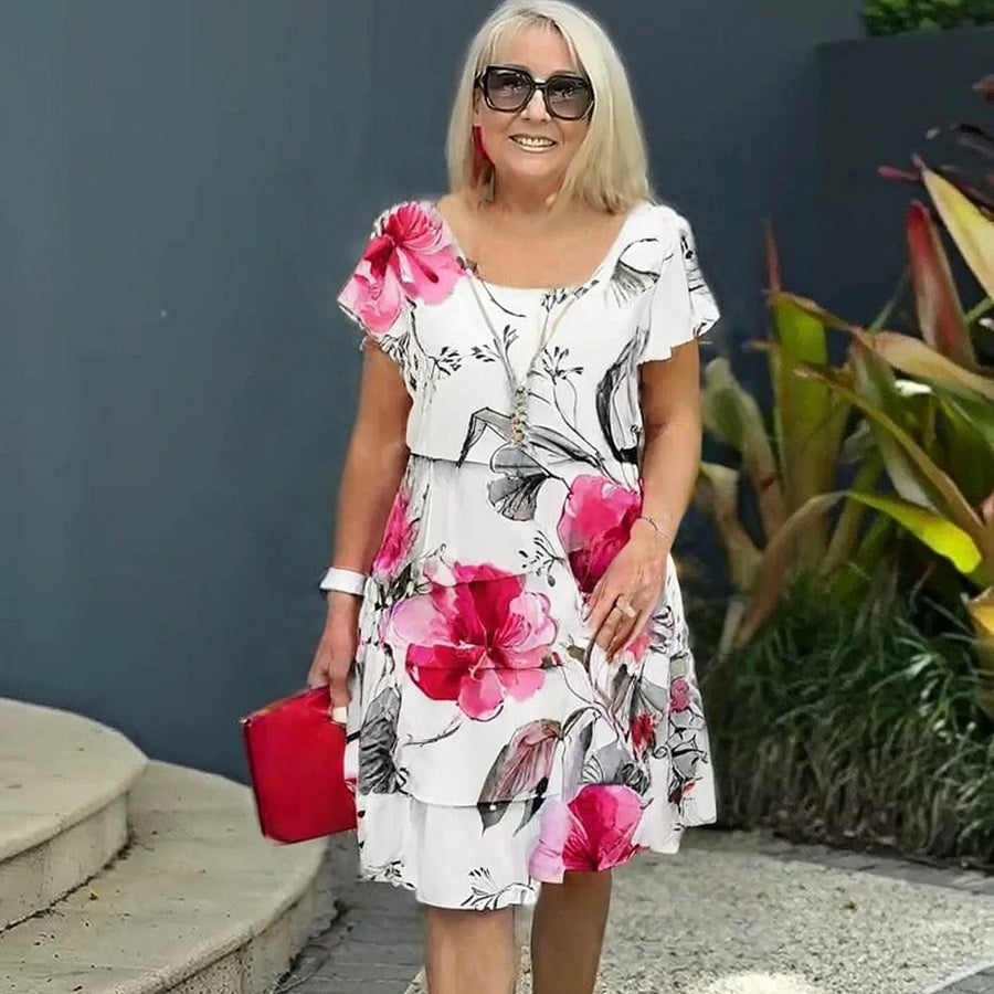Kjole med blomstertrykk i flere planter og kaskader